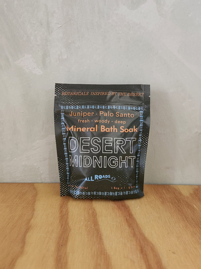 A green pouch of mineral bath salts containing palo santo and juniper essential oils. 