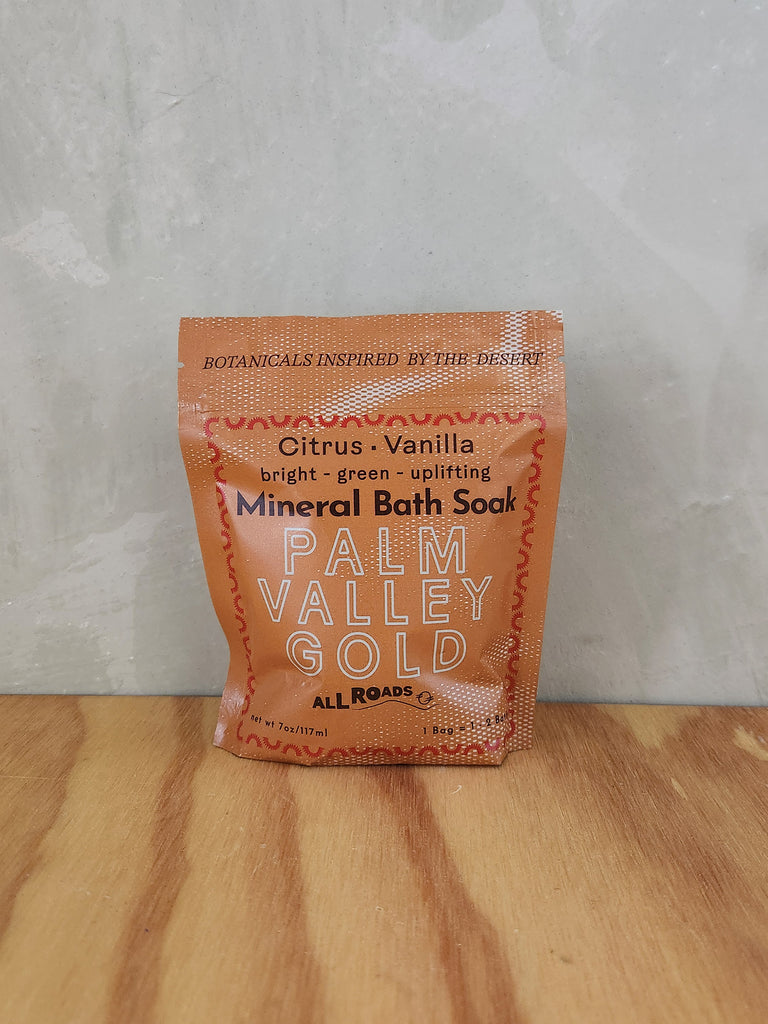 A yellow pouch of mineral bath salts containing citrus and vanilla essential oils. 
