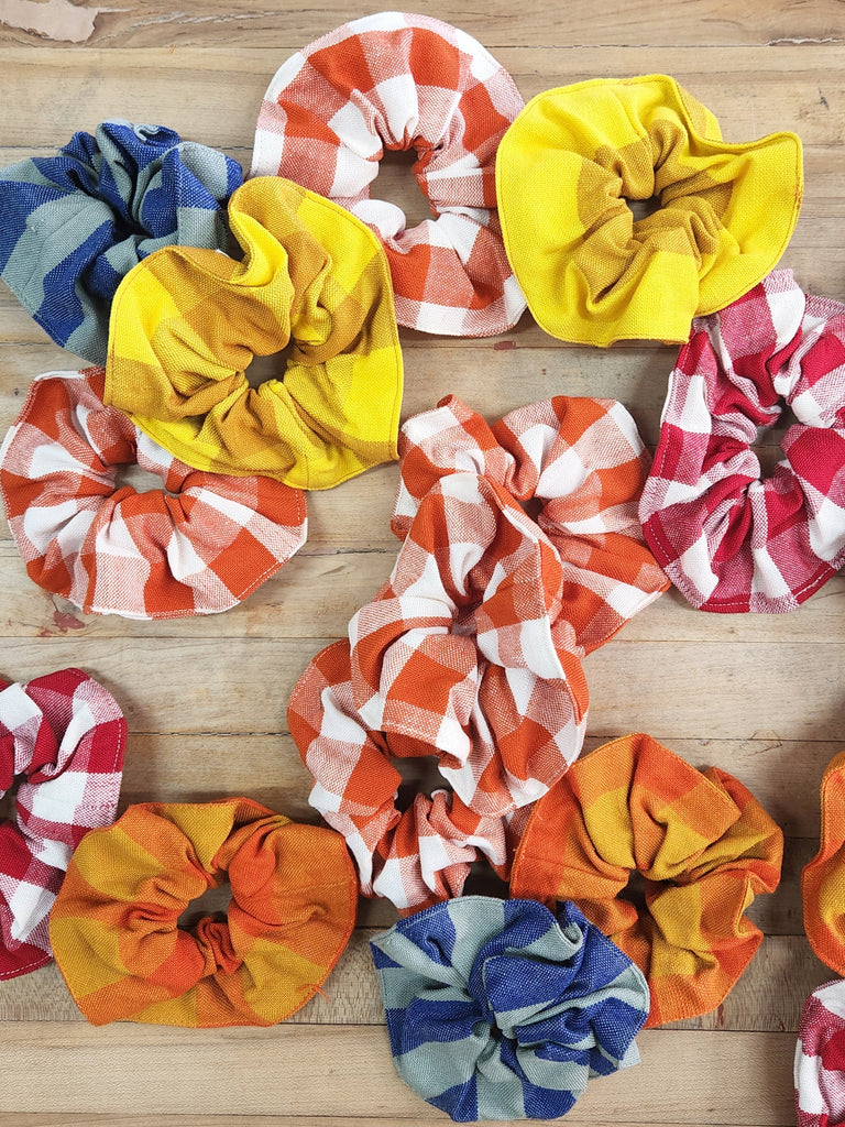 Cheerful scrunchies in a variety of primary color plaid and stripes. 