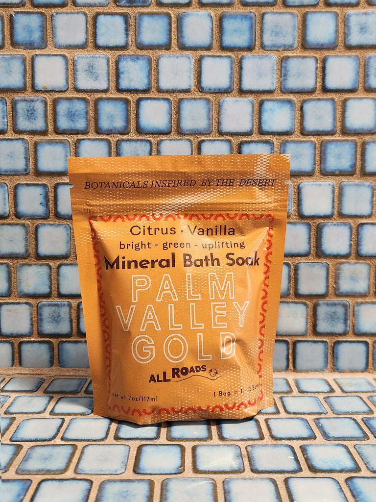 A warm yellow pouch of mineral bath salts containing citrus and vanilla essential oils. 