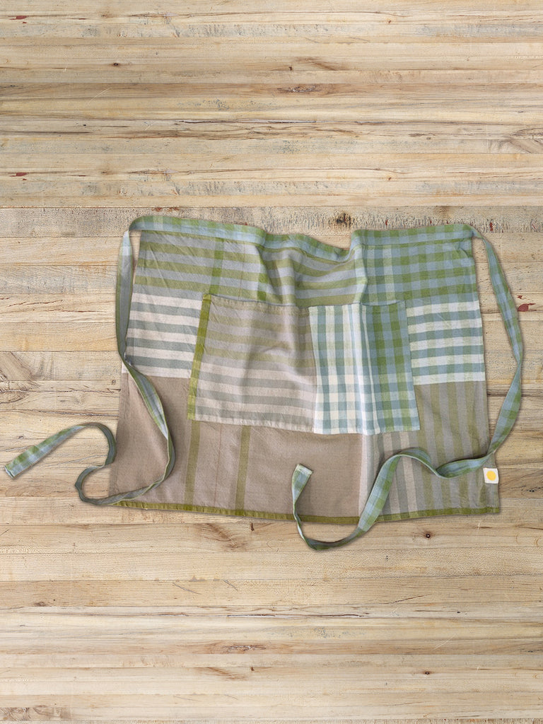 Green and cream plaid bistro apron with two front pockets.